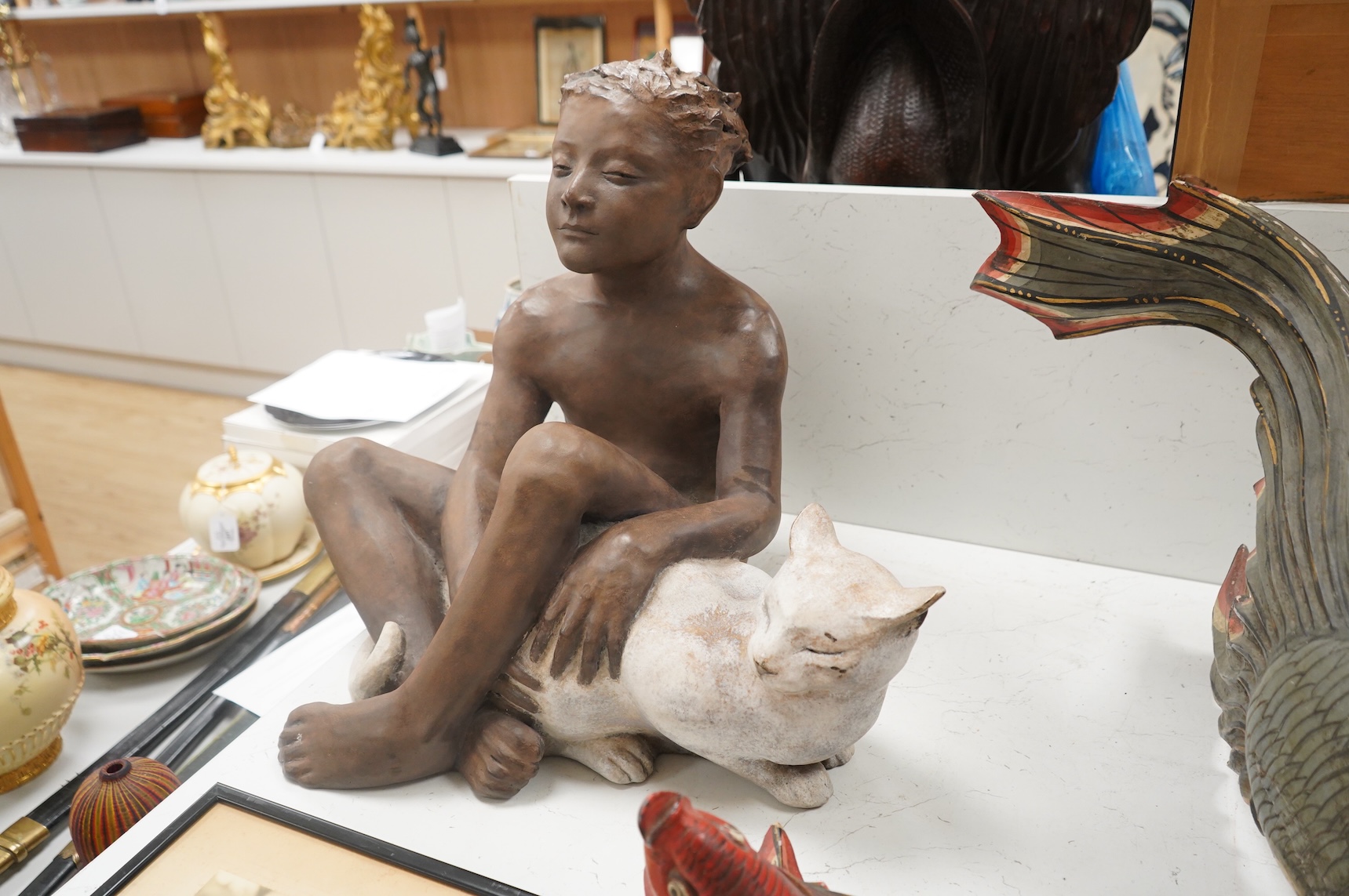 A contemporary composition figure of a seated boy and a cat, 46cm